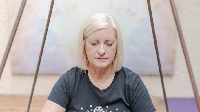 Caroline Evans, owner of Relaxtherapy, meditating with eyes closed