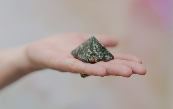 gemstone triangular crystal on hand